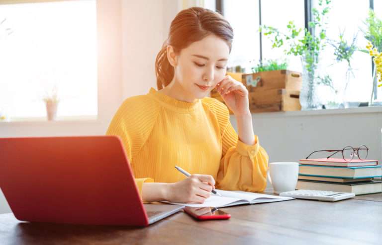 young woman working at a desk microcredentials