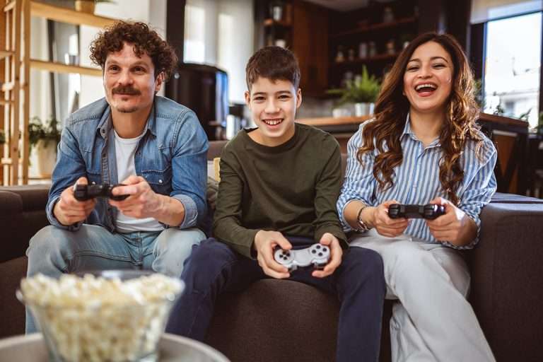Latino family playing video games with their controllers.