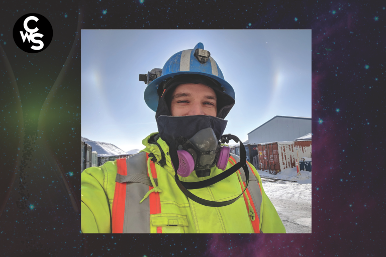 Person in hi-vis jacket wearing helmet and face mask