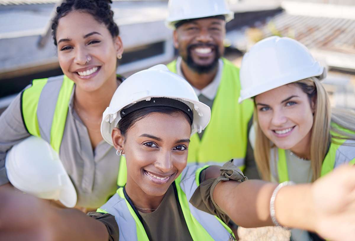 Selfie, engineer and staff outdoor, smile and construction site for real estate, new project and industrial. Portrait, coworkers and happy employees with success, hard hat for safety and management
