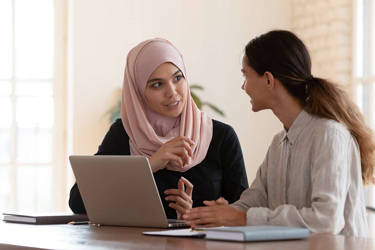 Two women in front of a laptop