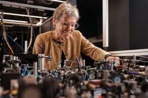An older lady surrounded by laser equipment