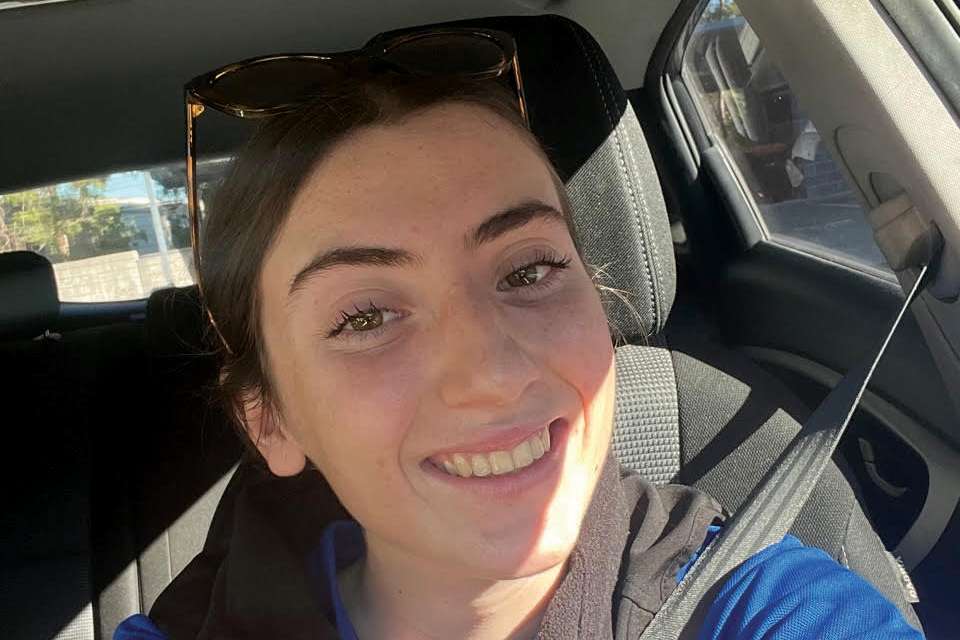 Woman in car with sunglasses on head