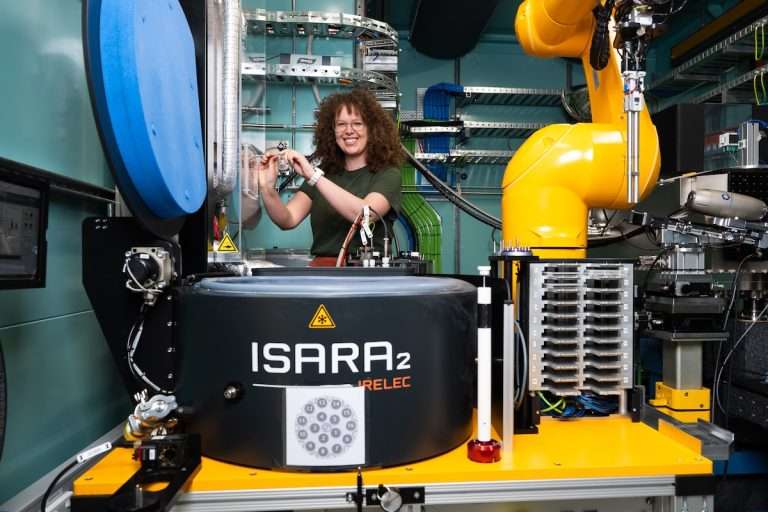 Woman wearing green t shirt working with an instrument