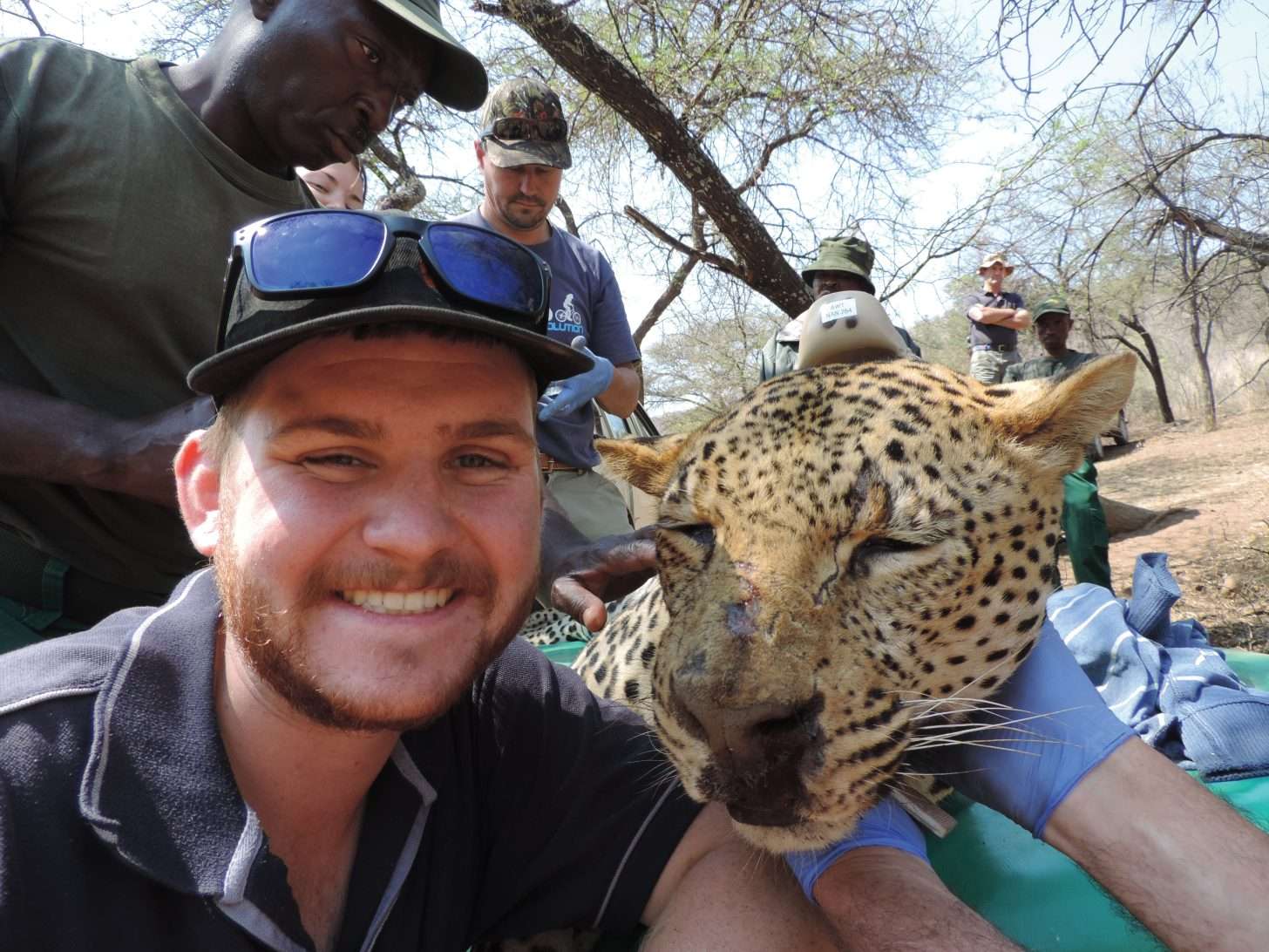Man next to leopard