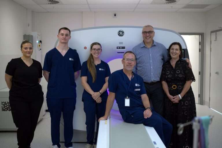 RMIT WA Nuclear Medicine Earn and Learn team wearing scrubs in front of a scanner