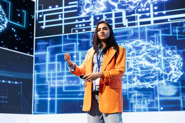 Technician presenting how artificial intelligence technologies can bring businesses increased productivity during IT expo. Expert talks about implementation of AI driven solutions during tech forum
