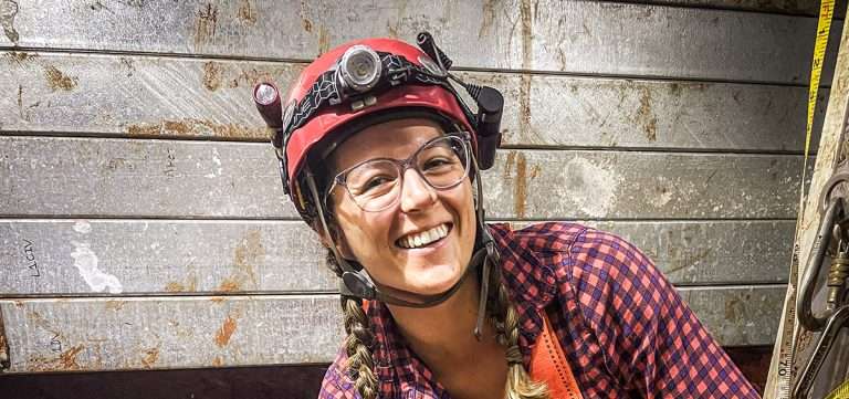Woman with hard hat and light