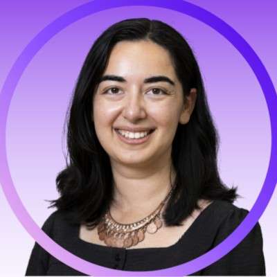 Woman with black hair and black dress, prominent necklace