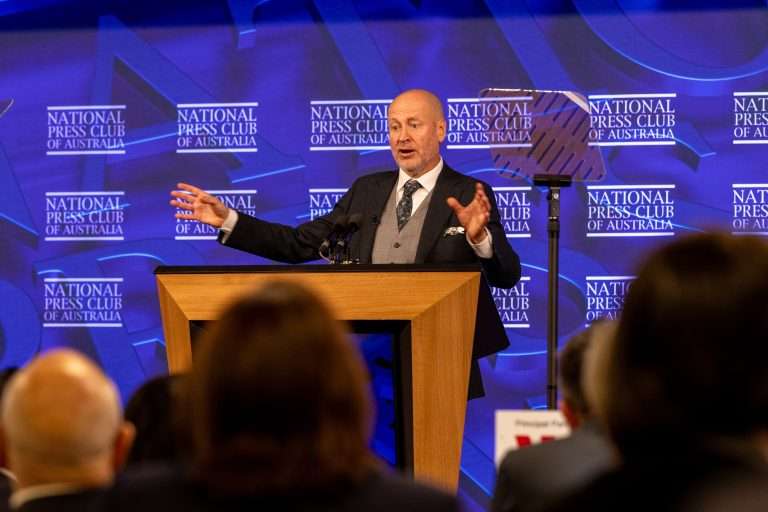 Man waving hands at the press club