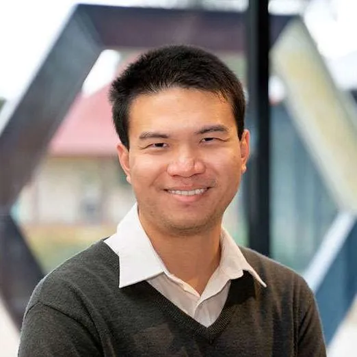 Man in white collared shirt with v-neck jumper